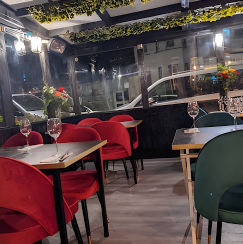 The Fanoos Persian Grill dining room with red velvet seating
