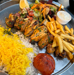 Mixed shish kebab platter with saffron rice, salad and chips at Fanoos Persian Grill